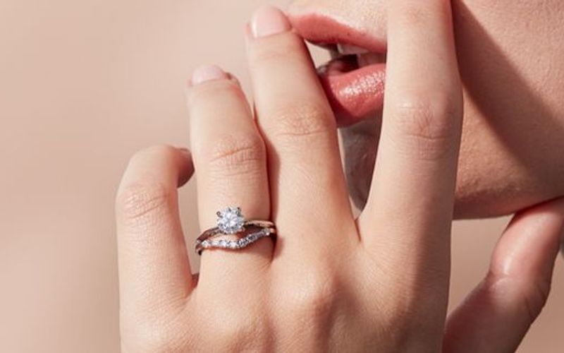 Diamond solitaire ring paired with curved diamond band Diamond solitaire ring paired with curved diamond band