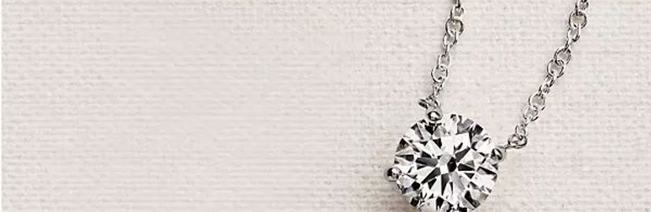 Close up of a lab grown diamond necklace featuring a solitaire diamond on a white gold chain. Close up of a lab grown diamond necklace featuring a solitaire diamond on a white gold chain.
